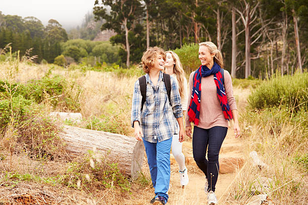 istock Mother and two kids walking on a forest trail 488709456