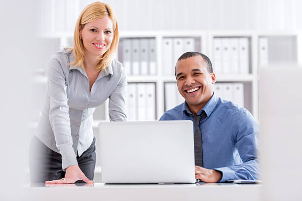 istock Happy business people using laptop in office. 488709738