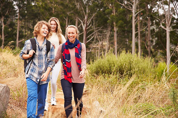 istock Happy mother and two kids walking in a forest 488711188