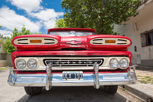 Salta, Argentina - December 19, 2014: Vintage red Chevrolet in the street of Salta with a clear blue sky, Argentina 2014