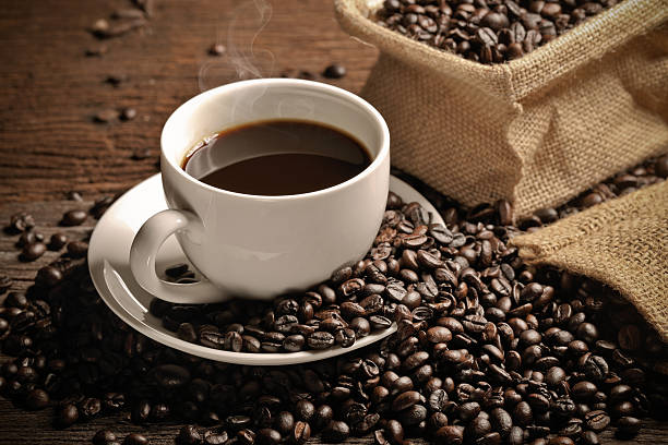 istock warm cup of coffee with sack inside by coffee bean 488713274