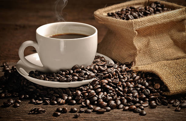 istock warm cup of coffee with sack inside by coffee bean 488713578