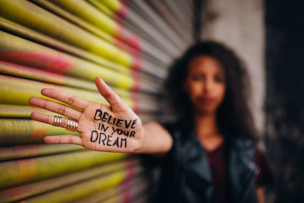 African American girl with inspirational meassage written on her hand Closeup of the hand of an African American girl with an inspirational message written on it in permanent marker permanent marker photos stock pictures, royalty-free photos & images