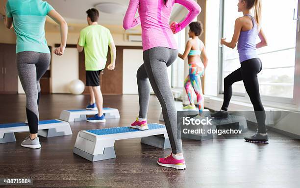 Close Up Of People Working Out With Steppers In Gym Stock Photo - Download Image Now