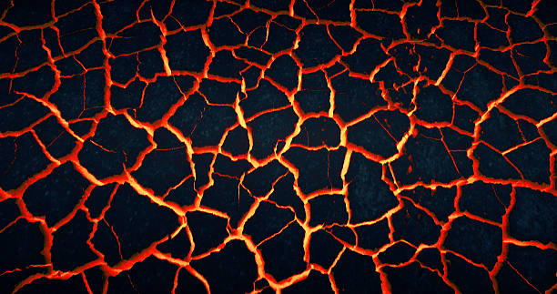 Wasteland. Lava glowing through cracks under dry ground stock photo
