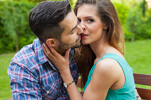 Couple sitting on the bench, they are in love. stock photo