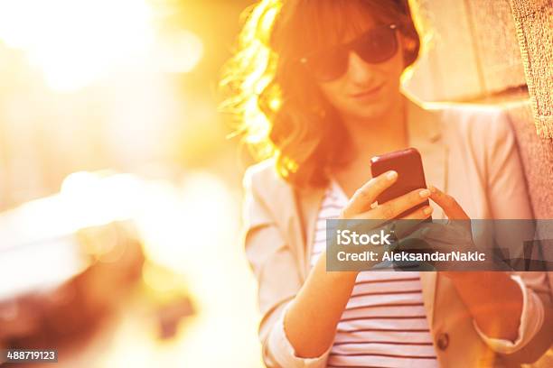 Using A Smartphone Outdoors Stock Photo - Download Image Now - 25-29 Years, Adult, Adults Only
