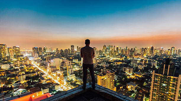 Man on top of skyscraper