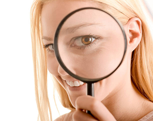 istock Woman with magnifier 488720460