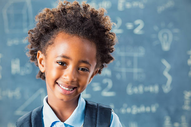 istock African American elementary schoolgirl in front of blackboard 488721244