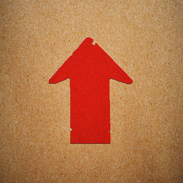 istock Up arrow icon in green on brown paper texture background 488721409