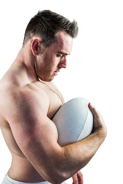 istock Shirtless rugby player holding ball 488721510