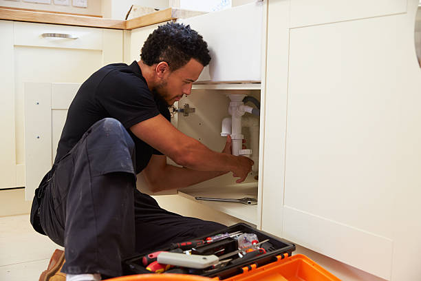 istock Mixed race plumber fixing the kitchen sink in a home 488721714
