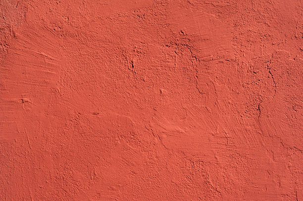 istock Texture of old wall covered with red stucco 488722022