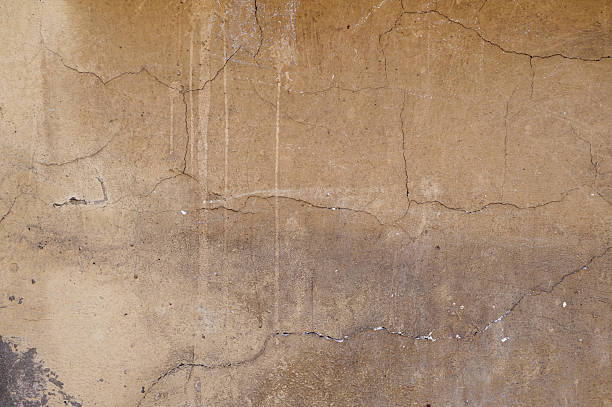istock Texture of old wall covered with brown stucco 488722496