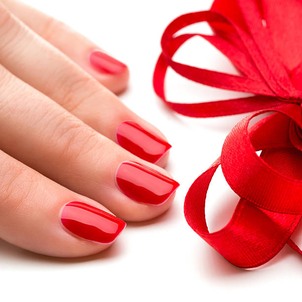 istock Woman hands with manicure red nails closeup 488722683