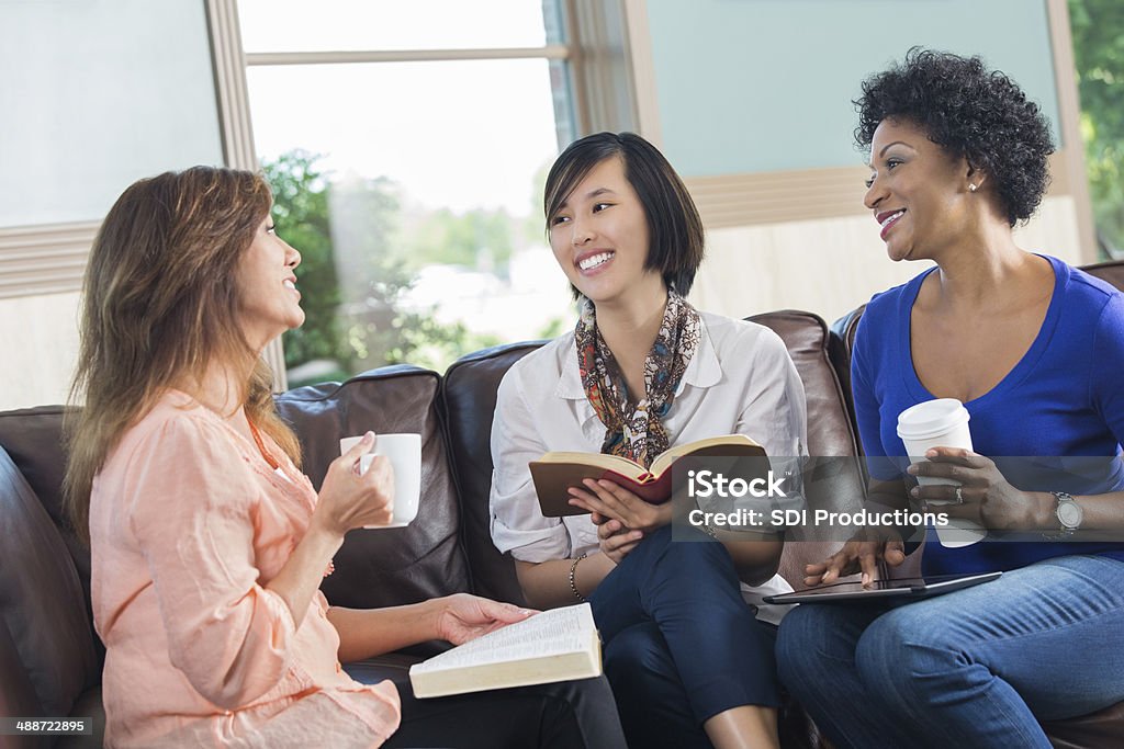Women having discussion during book club or bible study Book Club Stock Photo