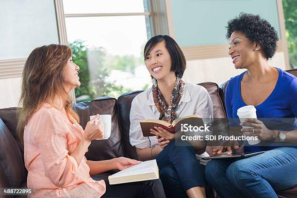 Women Having Discussion During Book Club Or Bible Study Stock Photo - Download Image Now