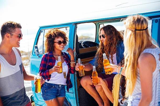 istock Friends having a beer near camper van 488723329