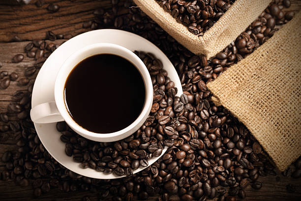 istock warm cup of coffee with sack inside by coffee bean 488755154