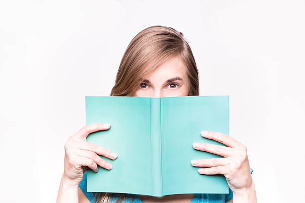 Isolated shot of a beautiful woman reading a book stock photo