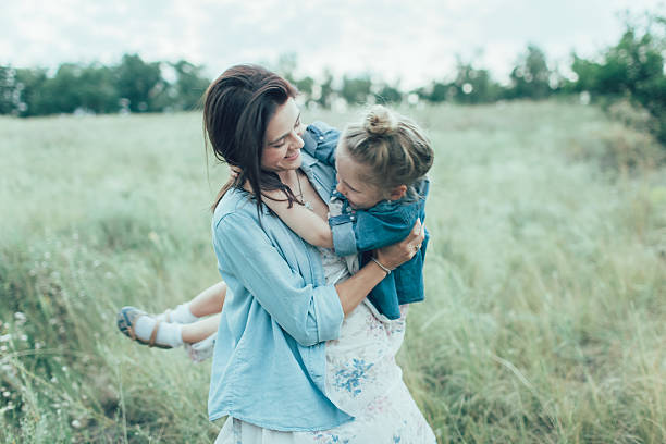 istock The young mother and daughter on green grass background 488755418