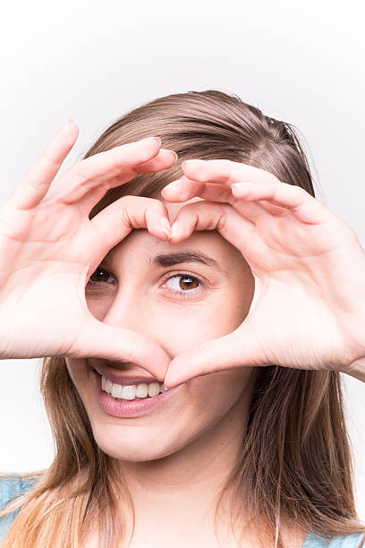istock Young Woman Makes Hands Heart Shape and Smiling 488755754