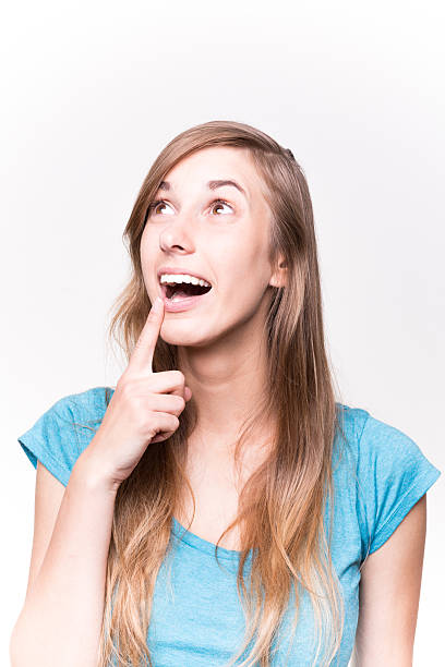 istock Young Woman Pointing With Her Finger Up White background 488755994