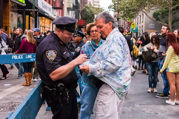 NYPD officer has fun with tourists at San Gennaro stock photo