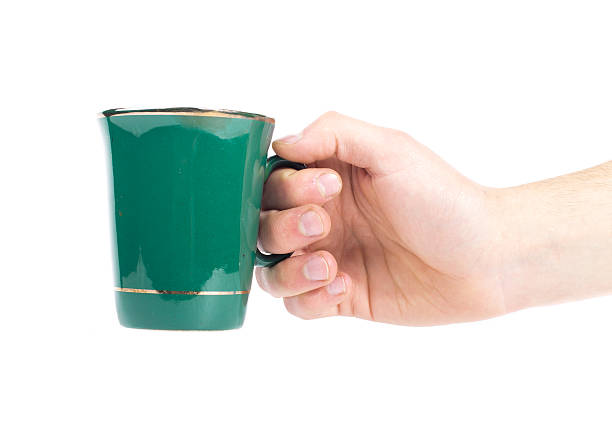 istock hand with green teacup isolated on a white background 488756934