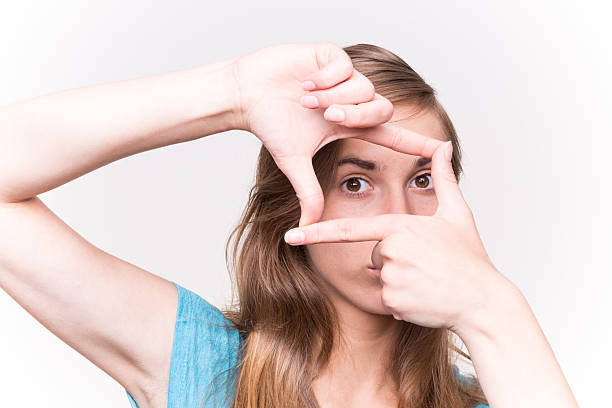 istock Happy Woman Looking Through Finger On White Background 488757084