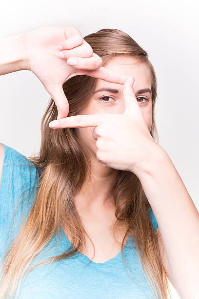 istock Happy Woman Looking Through Finger On White Background 488757146