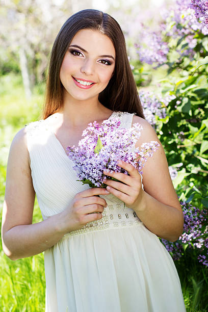 istock Beautiful girl with a lilac flowers 488757759