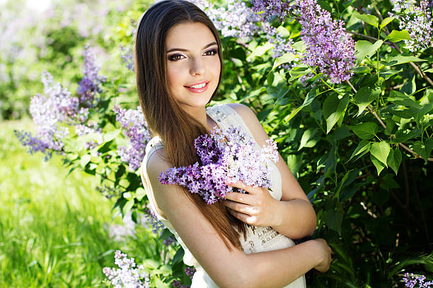 istock Beautiful girl with a lilac flowers 488757763