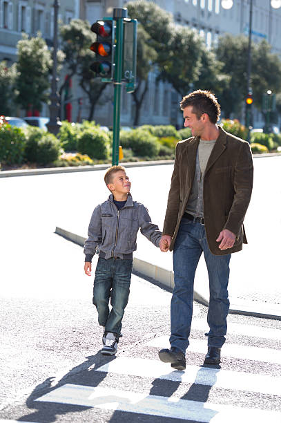 istock Father And Son Crossing The Cross Walk 488758513