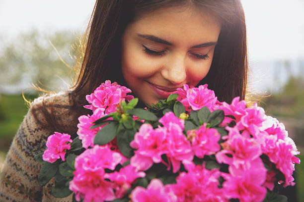 istock cute woman smelling pink flowers 488758637
