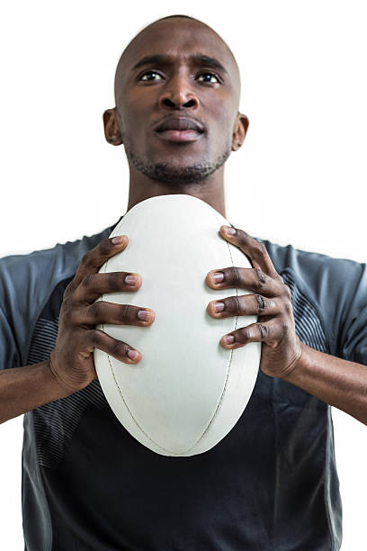 istock Cropped image of sportsman pressing rugby ball while looking up 488759248
