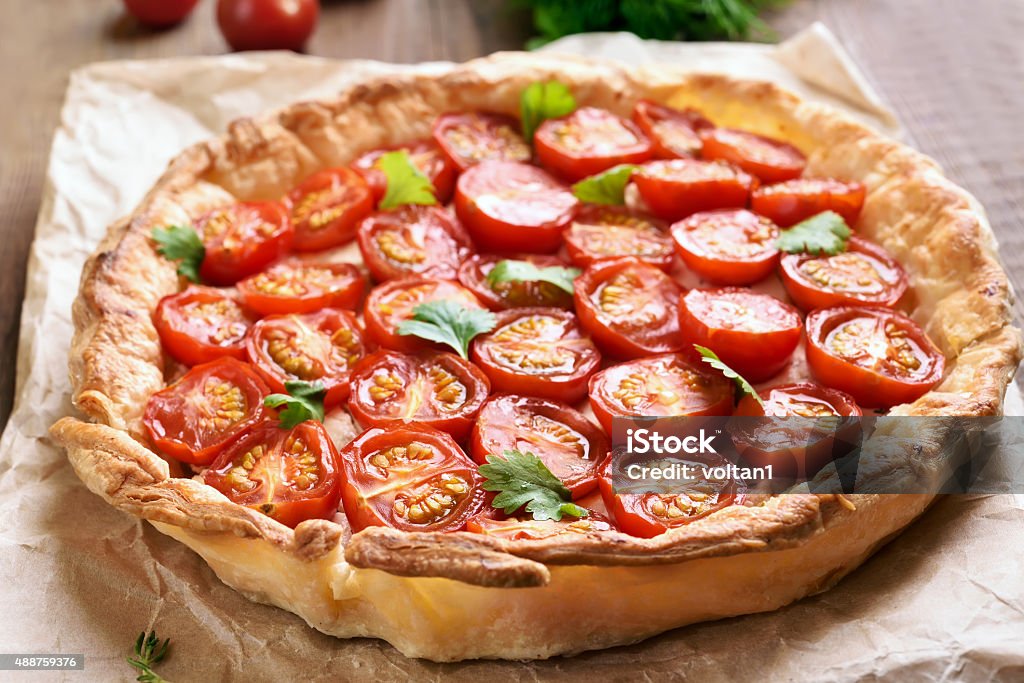 Tomato pie Tomato pie on baking paper, close up view Tomato Stock Photo