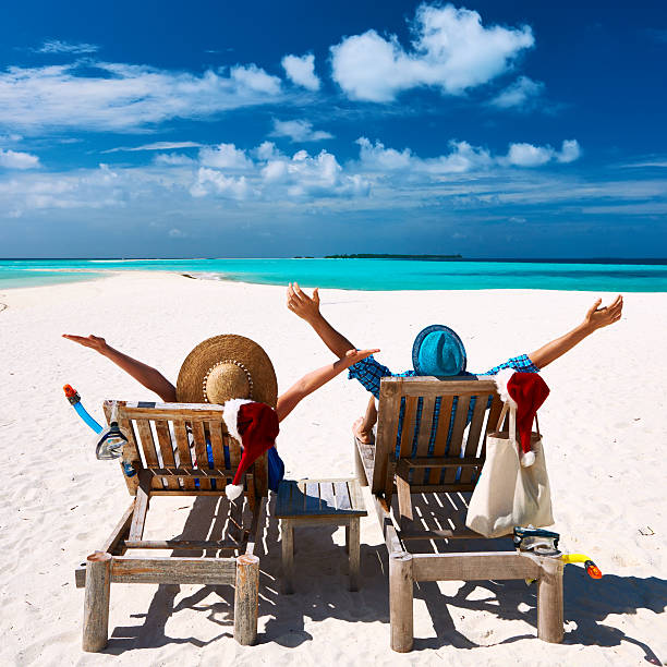 istock Couple relax on a beach at christmas 488760306