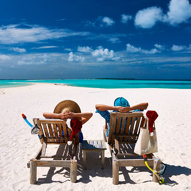 istock Couple relax on a beach at christmas 488760432