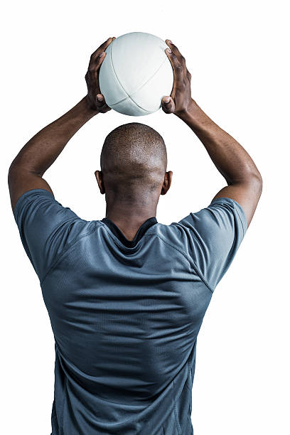 istock Rear view of athlete throwing rugby ball 488760604