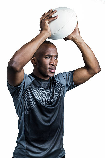 istock Confident sportsman throwing rugby ball 488760644