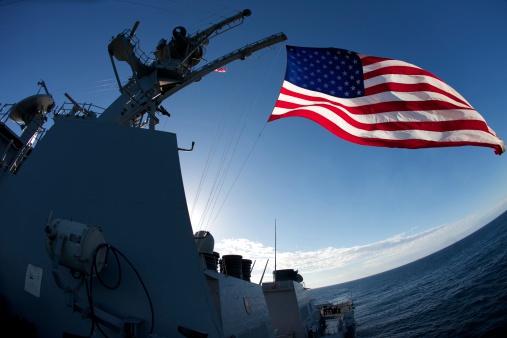 Pearl Harbor, USA - April 1st, 2022: American flags in front of USS Missouri. National historic sites at Pearl Harbor tell the story of the battle that plunged US into World War II.