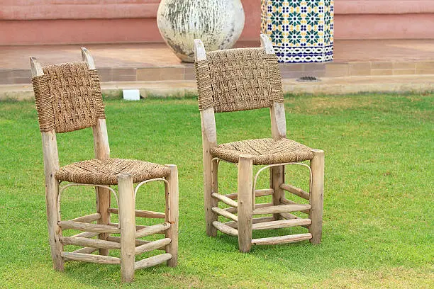 Grass lawn with a wicker chair