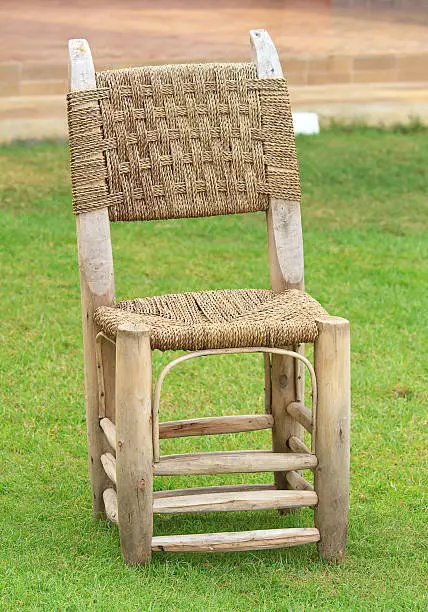 Grass lawn with a wicker chair