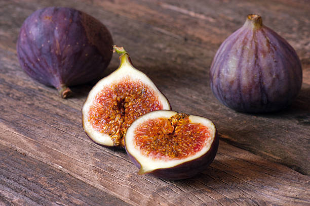 istock The cut fig on a wooden table. 488761488
