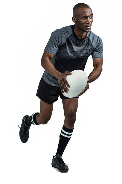 istock Confident athlete running with rugby ball 488761636
