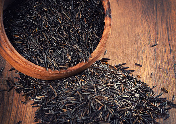 istock wild rice in a wooden bowl 488761689