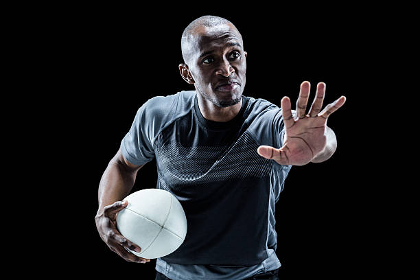 istock Serious sportsman gesturing while holding rugby ball 488762300