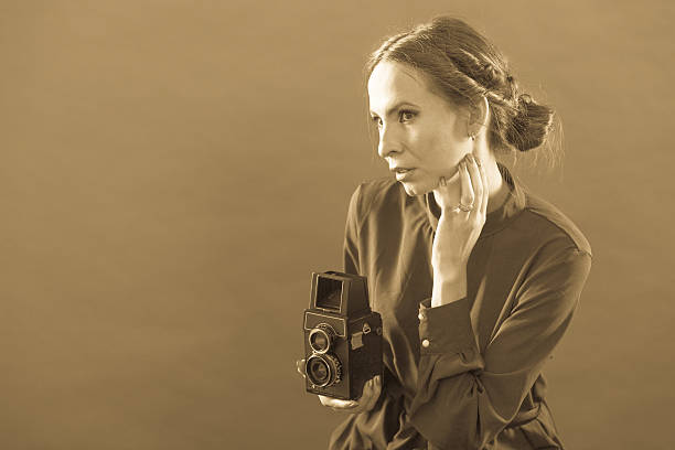 istock Woman taking picture with old camera 488762312
